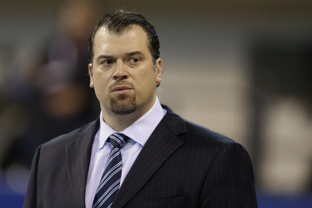 FILE - In this Dec. 15, 2013, file photo, Indianapolis Colts general manager Ryan Grigson watches warm-ups before an NFL football game against the Houston Texans in Indianapolis. The Colts are projected to be about $31 million under the salary cap heading into this offseason, and Grigson is looking to plug more holes on his team. (AP Photo/Darron Cummings, file)