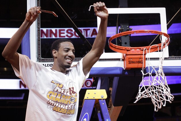 Minnesota's Austin Hollins (20) holds up part of the net after Minnesota defeated SMU 65-63 in an NCAA college basketball game in the final of the NIT on Thursday, April 3, 2014, in New York. (AP Photo/Frank Franklin II)