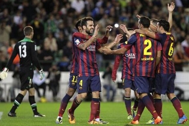 Barcelona's Francesc Fabregas, left, celebrates with teammates after scoring against Betis during their La Liga soccer match at the Benito Villamarin stadium, in Seville, Spain, Sunday, Nov. 10, 2013. (AP Photo/Angel Fernandez)