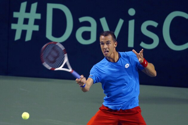 Lukas Rosol of the Czech Republic returns a shot to Taro Daniel of Japan during their quarterfinal of Davis Cup World Group tennis at Ariake Colosseum in Tokyo, Friday, April 4, 2014. (AP Photo/Shizuo Kambayashi)