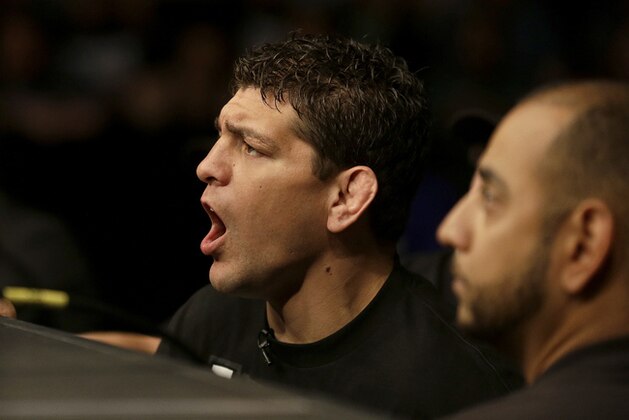 Nick Diaz, left, cheers on his brother Nate Diaz during a UFC lightweight mixed martial arts fight between Nate Diaz and Josh Thomson in San Jose, Calif., Saturday, April 20, 2013. Thomson won by technical knock out in the second round. (AP Photo/Jeff Chiu)