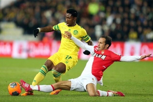 Nantes french forward Serge Gakpe is tackled by Monaco's defender Ricardo Carvalho during their French League One soccer match, Sunday, Nov. 24, 2013 in Nantes, western France. (AP Photo/David Vincent)