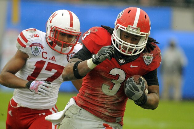 Georgia running back Todd Gurley (3) runs for yardage while being chased by Nebraska cornerback Ciante Evans (17) in the second half of the Gator Bowl NCAA college football game, Wednesday, Jan. 1, 2014, in Jacksonville, Fla. Nebraska beat Georgia 24-19. (AP Photo/Stephen B. Morton)