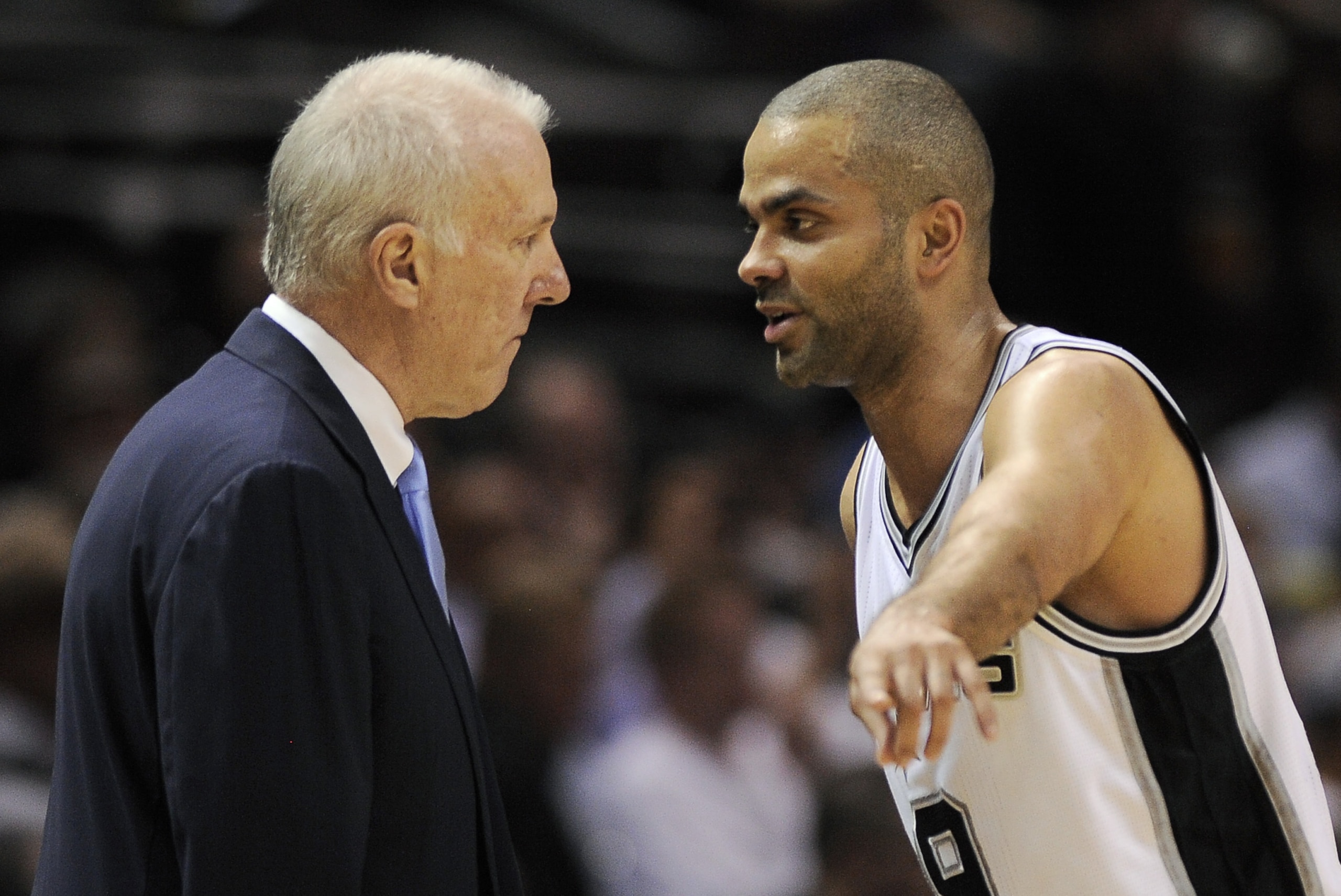 San Antonio Spurs guard Tony Parker, right, of France, talks to Spurs coach Gregg Popovich during the second half of an NBA basketball game against the Golden State Warriors, Wednesday, April 2, 2014, in San Antonio. San Antonio won 111-90. (AP Photo/Darren Abate)