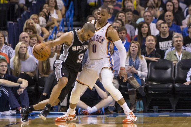 OKLAHOMA CITY, OK - April 3, 2014: Tony Parker #9 of the San Antonio Spurs drives against Russell Westbrook #0 of the Oklahoma City Thunder at the Chesapeake Arena on April 3, 2014 in Oklahoma City, Oklahoma. NOTE TO USER:  User expressly acknowledges and agrees that, by downloading and/or using this photograph, user is consenting to the terms and conditions of the Getty Images License Agreement. Mandatory Copyright Notice:  Copyright 2014 NBAE (Photo by Richard Rowe/NBAE via Getty Images)