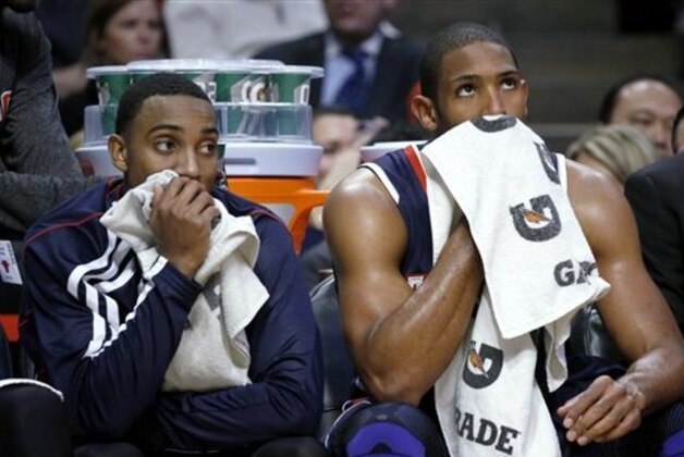 Atlanta Hawks' Jeff Teague, left, and Al Horford sit on the bench during the second half of an NBA basketball game against the Chicago Bulls on Monday, Jan. 14, 2013, in Chicago. The Bulls won 97-58. (AP Photo/Charles Rex Arbogast)