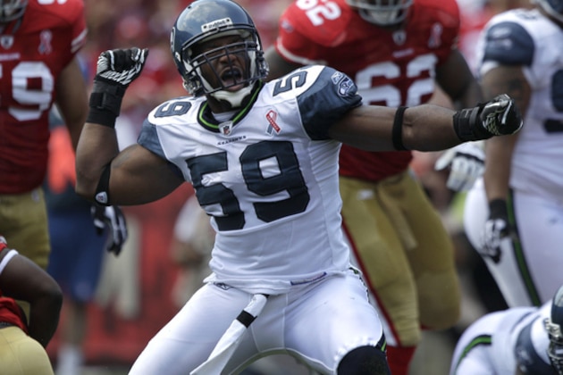 Seattle Seahawks linebacker Aaron Curry (59) celebrates after tackling San Francisco 49ers running back Frank Gore (21) in the first quarter of an NFL football game in San Francisco, Sunday, Sept. 11, 2011. (AP Photo/Marcio Jose Sanchez)