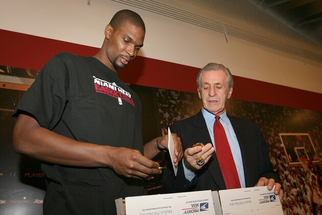 MIAMI - DECEMBER 21: Chris Bosh of the Miami Heat and President of the Miami Heat Pat Riley prepare Care Packages for Soldiers abroad on December 21, 2011 at American Airlines Arena in Miami, Florida. NOTE TO USER: User expressly acknowledges and agrees that, by downloading and/or using this Photograph, User is consenting to the terms and conditions of the Getty Images License Agreement. Mandatory copyright notice: Copyright NBAE 2011 (Photo by Issac Baldizon/NBAE via Getty Images)