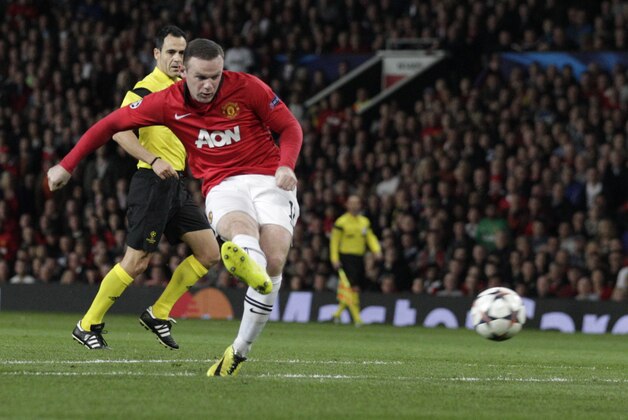 Manchester United's Wayne Rooney shoots a ball during the Champions League quarterfinal first leg soccer match between Manchester United and Bayern Munich at Old Trafford Stadium, Manchester, England, Tuesday, April 1, 2014.(AP Photo/Jon Super)