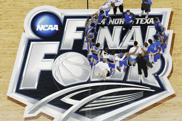 Kentucky huddles with head coach John Calipari during practice for their NCAA Final Four tournament college basketball semifinal game Friday, April 4, 2014, in Dallas. Kentucky plays Wisconsin on Saturday, April 5, 2014. (AP Photo/David J. Phillip)