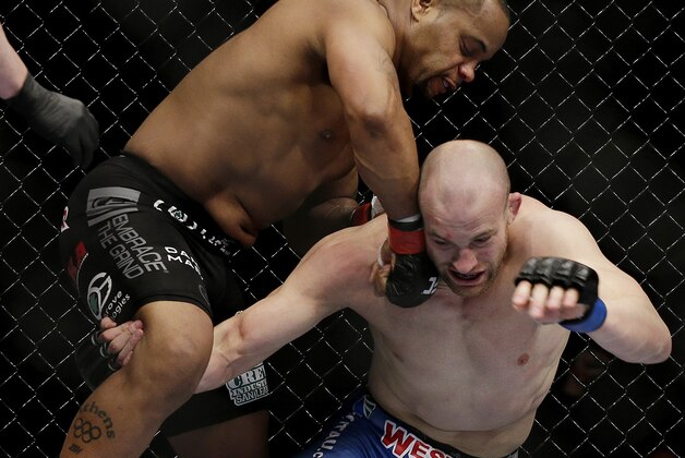 Daniel Cormier punches Patrick Cummins during a UFC 170 mixed martial arts light heavyweight fight Saturday, Feb. 22, 2014, in Las Vegas. Cormier won the bout. (AP Photo/Isaac Brekken)