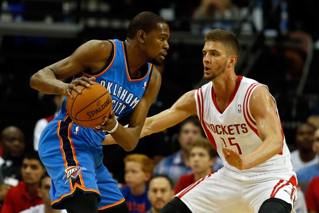 HOUSTON, TX - APRIL 04:  Kevin Durant #35 of the Oklahoma City Thunder drives to the basket against Chandler Parsons #25 of the Houston Rockets during a game at the Toyota Center on April 4, 2014 in Houston, Texas. NOTE TO USER: User expressly acknowledges and agrees that, by downloading and or using this photograph, User is consenting to the terms and conditions of the Getty Images License Agreement.  (Photo by Scott Halleran/Getty Images)