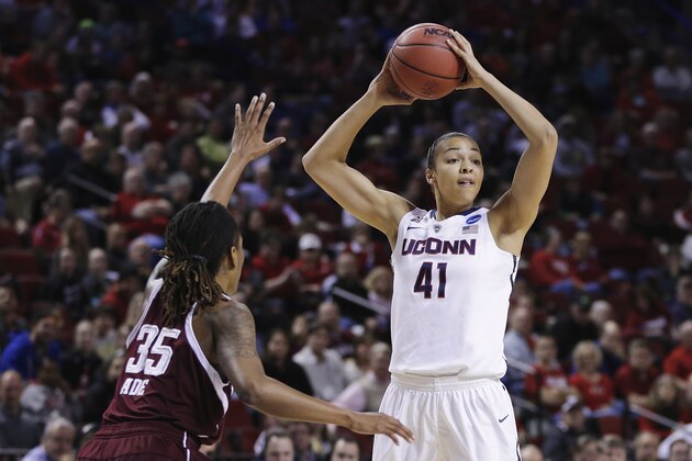 Connecticut's Kiah Stokes (41) is defended by Texas A&M's Achiri Ade (35) during the first half of a regional final game in the NCAA college basketball tournament in Lincoln, Neb., Monday, March 31, 2014. (AP Photo/Nati Harnik)