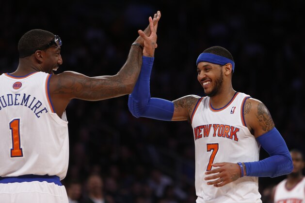 New York Knicks' Carmelo Anthony (7) celebrates with teammate Amar'e Stoudemire (1) after hitting a 3-point shot against the Dallas Mavericks during the second half of an NBA basketball game Monday, Feb. 24, 2014, in New York.  Dallas won 110-108. (AP Photo/Jason DeCrow)