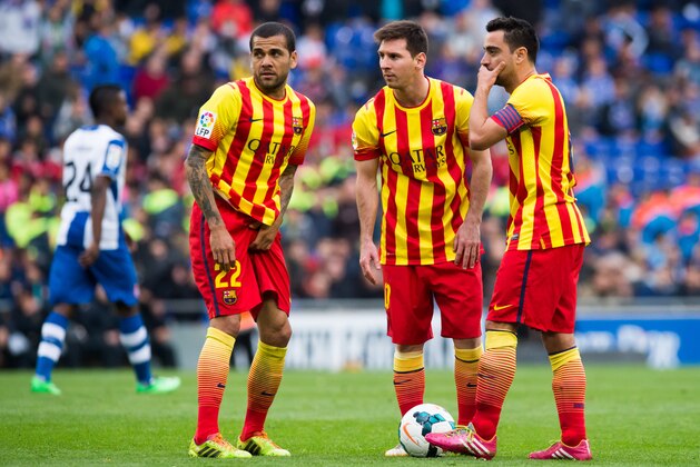 BARCELONA, SPAIN - MARCH 29: (L-R) Daniel Alves, Lionel Messi and Xavi Hernandez of FC Barcelona speak during the La Liga match between RCD Espanyol and FC Barcelona at Cornella-El Prat Stadium on March 29, 2014 in Barcelona, Spain. (Photo by Alex Caparros/Getty Images)