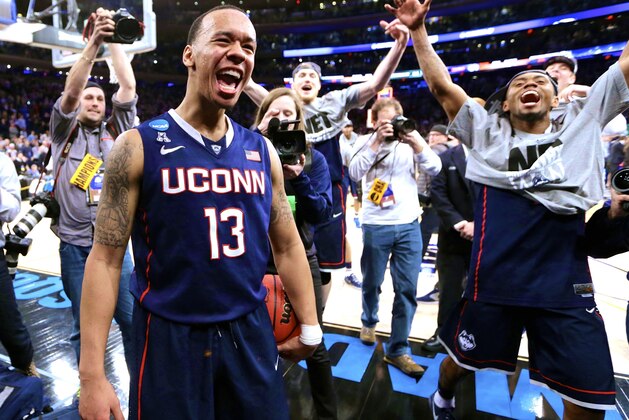 Connecticut's Shabazz Napier (13) celebrates after his team defeated Michigan State 60-54 in a regional final at the NCAA college basketball tournament, Sunday, March 30, 2014, in New York. Napier scored 17 points of his 25 points in the second half. (AP Photo/Frank Franklin II)
