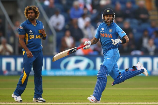 CARDIFF, WALES - JUNE 20:  Virat Kohli (R) of India takes another run as Lasith Malinga (L) of Sri Lanka looks on during the ICC Champions Trophy Semi-Final match between India and Sri Lanka at the SWALEC Stadium on June 20, 2013 in Cardiff, Wales.  (Photo by Michael Steele/Getty Images)