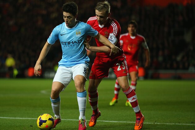 SOUTHAMPTON, ENGLAND - DECEMBER 07: Samir Nasri of Manchester City holds back Luke Shaw of Southampton during the Barclays Premier League match between Southampton and Manchester City at St Marys Stadium on December 07, 2013 in Southampton, England.  (Photo by Bryn Lennon/Getty Images)