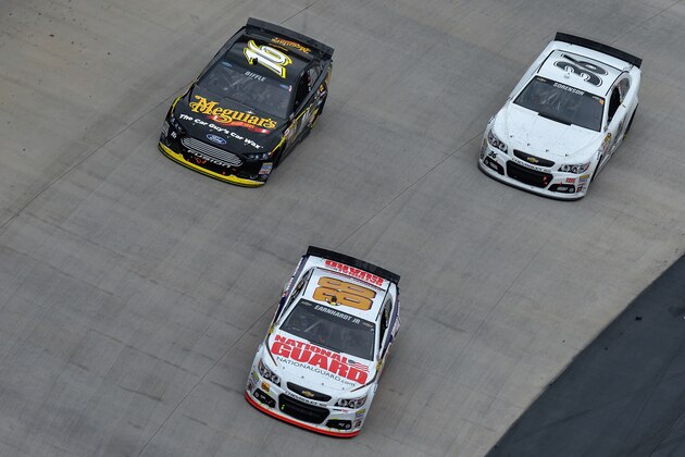 BRISTOL, TN - MARCH 16: Dale Earnhardt Jr., driver of the #88 National Guard Chevrolet, leads Greg Biffle, driver of the #16 Meguiar's Ford, and Reed Sorenson, driver of the #36 Chevrolet, during the NASCAR Sprint Cup Series Food City 500 at Bristol Motor Speedway on March 16, 2014 in Bristol, Tennessee.  (Photo by Drew Hallowell/Getty Images)