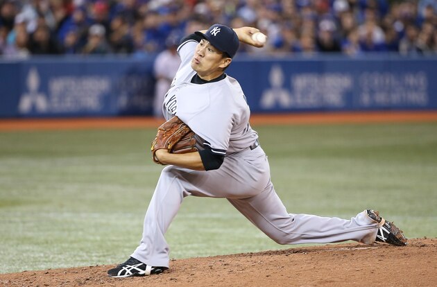TORONTO, CANADA - APRIL 4: Masahiro Tanaka #19 of the New York Yankees delivers a pitch in the second inning during MLB game action against the Toronto Blue Jays on April 4, 2014 at Rogers Centre in Toronto, Ontario, Canada. (Photo by Tom Szczerbowski/Getty Images)