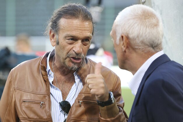 Atalanta President Antonio Percassi, right, talks with Cagliari President Massimo Cellino prior to the Serie A soccer match between Cagliari and Atalanta, at the Nereo Rocco Stadium in Trieste, Italy, Sunday, Aug. 25, 2013. (AP Photo/Paolo Giovannini)