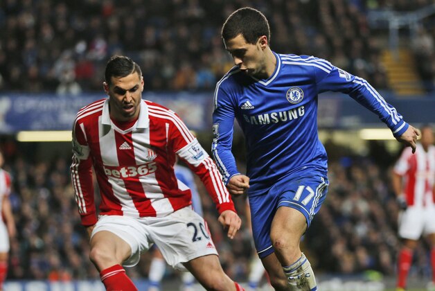 Chelsea's Eden Hazard, right, controls the ball in front of Stoke City's Geoff Cameron, left, during an English FA Cup 4th round soccer match against Stoke City at the Stamford Bridge ground in London, Sunday, Jan. 26, 2014. Chelsea won the match 1-0. (AP Photo/Lefteris Pitarakis)