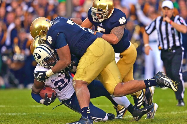 SOUTH BEND, IN - OCTOBER 20: Jamaal Williams #21 of the BYU Cougars is dropped by Stephon Tuitt #7, Louis Nix III #9 and Manti T'eo #5 of the Notre Dame Fighting Irish at Notre Dame Stadium on October 20, 2012 in South Bend, Indiana. Notre Dame defeated BYU 17-14. (Photo by Jonathan Daniel/Getty Images)