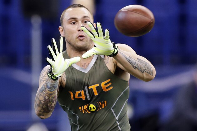In this Feb. 22, 2014 photo, Oregon tight end Colt Lyerla runs a drill at the NFL football scouting combine in Indianapolis. Lyerla, who sat stone-faced at a table taking question after question from the media about how he turned his life around following a cocaine arrest last fall, will face tougher questions from NFL teams. (AP Photo/Michael Conroy)
