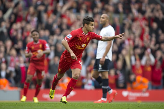 Liverpool's Philippe Coutinho celebrates after scoring against Tottenham during their English Premier League soccer match at Anfield Stadium, Liverpool, England, Sunday March 30, 2014. (AP Photo/Jon Super)
