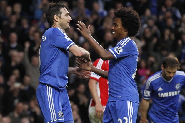 Chelsea's Frank Lampard, left, celebrates his goal against Stoke City with teammate Willian during their English Premier League soccer match at Stamford Bridge, London, Saturday, April 5, 2014. (AP Photo/Sang Tan)