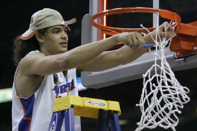 Florida's Joakim Noah (13) cutws down the net after the Gators defeated Ohio State 84-75 in the the Final Four basketball championship at Georgia Dome in Atlanta, Monday, April 2, 2007. (AP Photo/Gerry Broome)