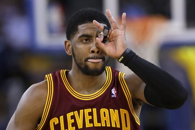 Cleveland Cavaliers guard Kyrie Irving celebrates after making a 3-point basket against the Golden State Warriors during the second half of an NBA basketball game Friday, March 14, 2014, in Oakland, Calif. Cleveland won 103-94. (AP Photo/Marcio Jose Sanchez)