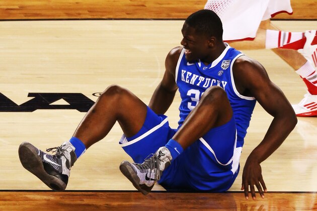 ARLINGTON, TX - APRIL 05: Julius Randle #30 of the Kentucky Wildcats falls to the ground during the NCAA Men's Final Four Semifinal against the Wisconsin Badgers at AT&T Stadium on April 5, 2014 in Arlington, Texas.  (Photo by Ronald Martinez/Getty Images)
