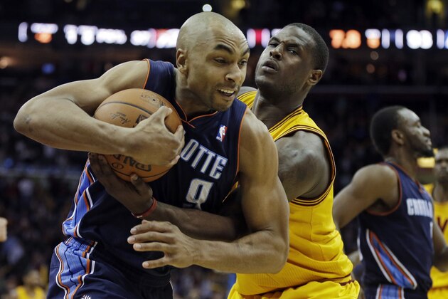 Cleveland Cavaliers' Dion Waiters, right, fouls Charlotte Bobcats' Gerald Henderson in overtime of an NBA basketball game Saturday, April 5, 2014, in Cleveland. (AP Photo/Mark Duncan)