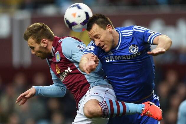 BIRMINGHAM, ENGLAND - MARCH 15:  John Terry of Chelsea jumps with Andreas Weimann of Aston Villa during the Barclays Premier League match between Aston Villa and Chelsea at Villa Park on March 15, 2014 in Birmingham, England.  (Photo by Michael Regan/Getty Images)