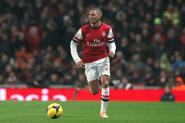 Arsenal's Kieran Gibbs runs with the ball during their English Premier League soccer match between Arsenal and Chelsea at the Emirates stadium in London, Monday, Dec. 23, 2013. (AP Photo/Alastair Grant)