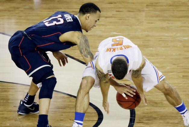 Connecticut guard Shabazz Napier (13) and Florida guard Scottie Wilbekin (5) reach for a loose ball during the second half of the NCAA Final Four tournament college basketball semifinal game Saturday, April 5, 2014, in Arlington, Texas. (AP Photo/Tony Gutierrez) Connecticut guard Shabazz Napier (13) and Florida guard Scottie Wilbekin (5) reach for a loose ball during the second half of the NCAA Final Four tournament college basketball semifinal game Saturday, April 5, 2014, in Arlington, Texas. (AP Photo/Tony Gutierrez)