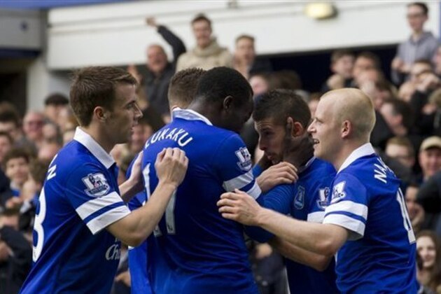 Everton's Kevin Mirallas, centre right, celebrates with teammates after scoring against Arsenal during their English Premier League soccer match at Goodison Park Stadium, Liverpool, England, Sunday April 6, 2014. (AP Photo/Jon Super)