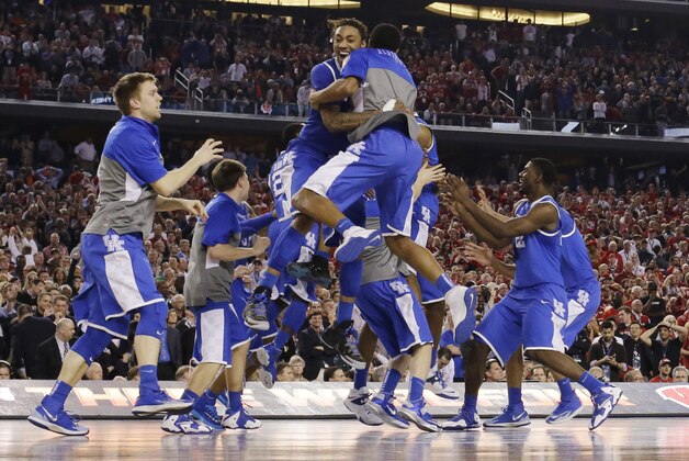 Kentucky celebrates after guard Aaron Harrison made a three-point basket in the final seconds against Wisconsin to win the game 74-73 during their NCAA Final Four tournament college basketball semifinal game Saturday, April 5, 2014, in Arlington, Texas. (AP Photo/David J. Phillip) Kentucky celebrates after guard Aaron Harrison made a three-point basket in the final seconds against Wisconsin to win the game 74-73 during their NCAA Final Four tournament college basketball semifinal game Saturday, April 5, 2014, in Arlington, Texas. (AP Photo/David J. Phillip)