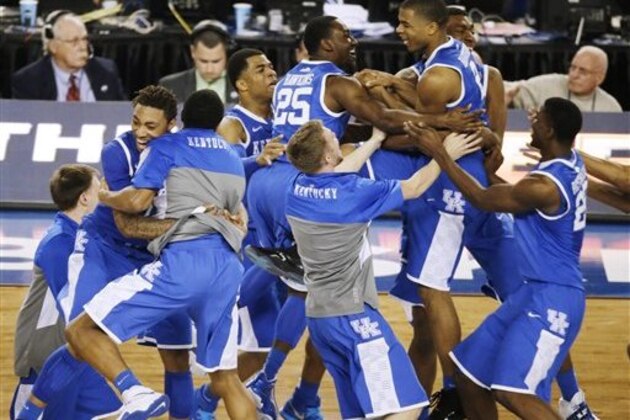 Kentucky celebrates after guard Aaron Harrison made a three-point basket in the final seconds against Wisconsin to win the game 74-73 during their NCAA Final Four tournament college basketball semifinal game Saturday, April 5, 2014, in Arlington, Texas. (AP Photo/Tony Gutierrez)