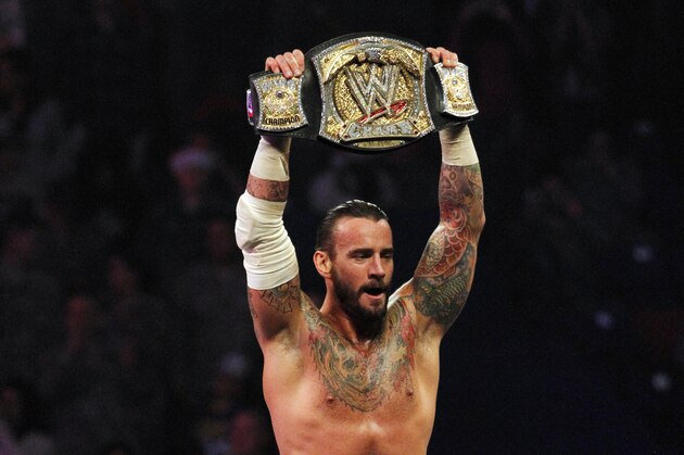 In this Dec. 11, 2011 photo released by the WWE, WWE Champion CM Punk performs during WWE’s 9th annual