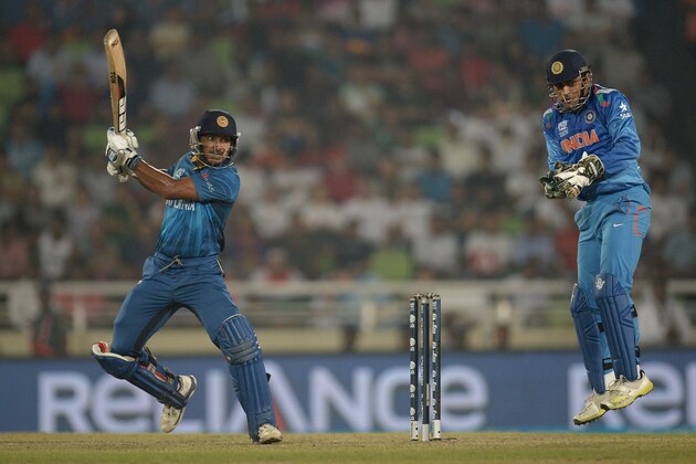 DHAKA, BANGLADESH - APRIL 06:  Kumar Sangakkara of Sri Lanka hits the ball past Mahendra Singh Dhoni of India during the ICC World Twenty20 Bangladesh 2014 Final between India and Sri Lanka at Sher-e-Bangla Mirpur Stadium on April 6, 2014 in Dhaka, Bangladesh.  (Photo by Gareth Copley/Getty Images)
