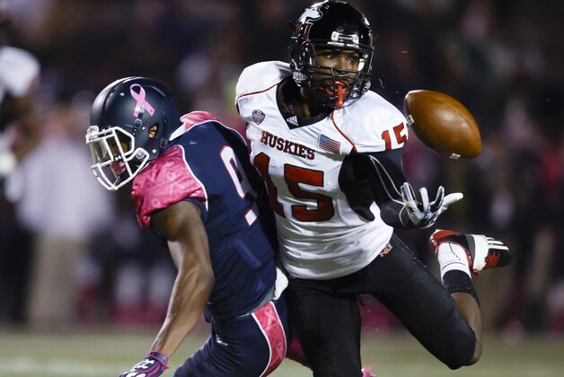 Northern Illinois safety Jimmie Ward (15) intercepts a pass intended for Toledo wide receiver Alonzo Russell (9) in the first quarter an NCAA college football game in Toledo, Ohio, Wednesday, Nov. 20, 2013. (AP Photo/Rick Osentoski)