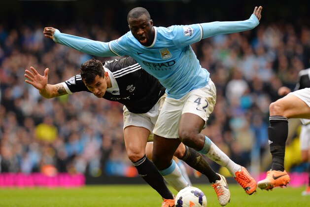 MANCHESTER, ENGLAND - APRIL 05:  Yaya Toure of Manchester City is challenged by Jose Fonte of Southampton during the Barclays Premier League match between Manchester City and Southampton at Etihad Stadium on April 5, 2014 in Manchester, England.  (Photo by Shaun Botterill/Getty Images)
