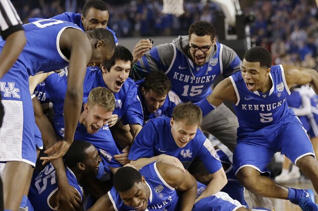 Kentucky players celebrate on the court after their 74-73 victory over Wisconsin in an NCAA Final Four tournament college basketball semifinal game Saturday, April 5, 2014, in Arlington, Texas. (AP Photo/Eric Gay)