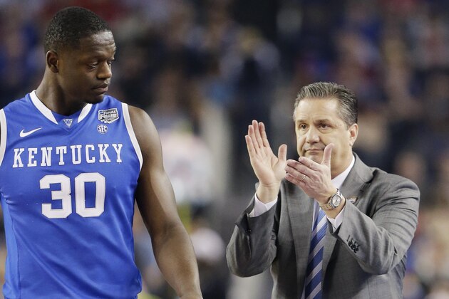 Kentucky head coach John Calipari cheers on players including forward Julius Randle (30) during the first half of the NCAA Final Four tournament college basketball semifinal game against Wisconsin Saturday, April 5, 2014, in Arlington, Texas. (AP Photo/Eric Gay)