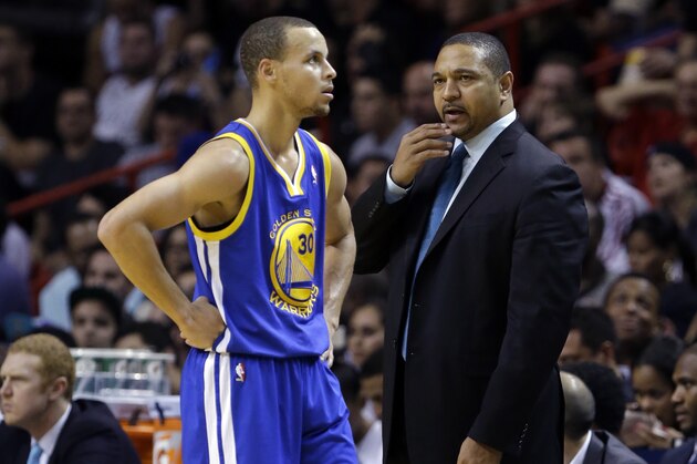 Golden State Warriors head coach Mark Jackson talks with Golden State Warriors' Stephen Curry (30) during the second half of an NBA basketball game against the Miami Heat, Thursday, Jan. 2, 2014, in Miami. The Warriors defeated the Heat 123-114. (AP Photo/Lynne Sladky)