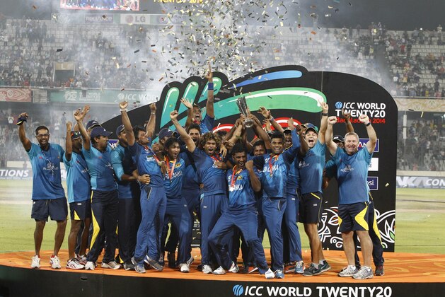 Sri Lanka’s players and team officials pose for a group photo while celebrating with the  trophy after winning the ICC Twenty20 Cricket World Cup in Dhaka, Bangladesh, Sunday, April 6, 2014. Sri Lanka won the title defeating India by six wickets. (AP Photo/A.M. Ahad)