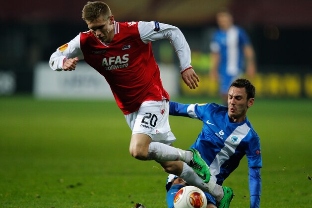 ALKMAAR, NETHERLANDS - FEBRUARY 27:  Aron Johannsson of AZ is tackled by Serhiy Rybalka of Slovan Liberec during the UEFA Europa League Round of 32 match between AZ Alkmaar and FC Slovan Liberec at the AZ Stadium on February 27, 2014 in Alkmaar, Netherlands.  (Photo by Dean Mouhtaropoulos/Getty Images)