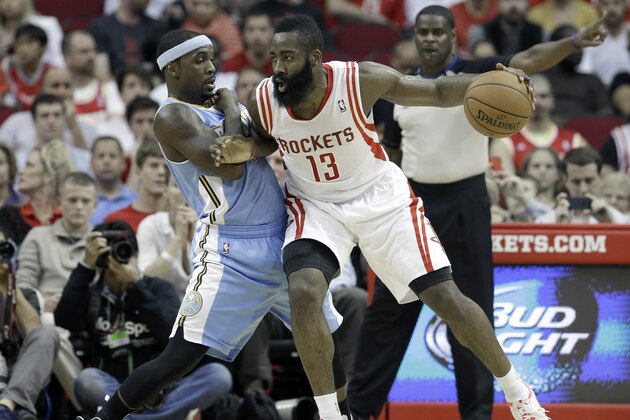 Houston Rockets' James Harden (13) pushes against Denver Nuggets' Ty Lawson in the first half of an NBA basketball game Saturday, Nov. 16, 2013, in Houston. (AP Photo/Pat Sullivan)